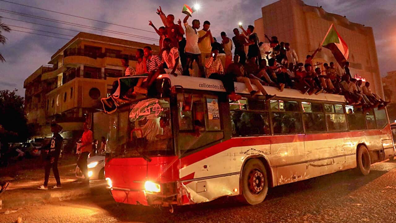 Sudanese people gather on a bus as they celebrate after the signature of the power sharing agreement