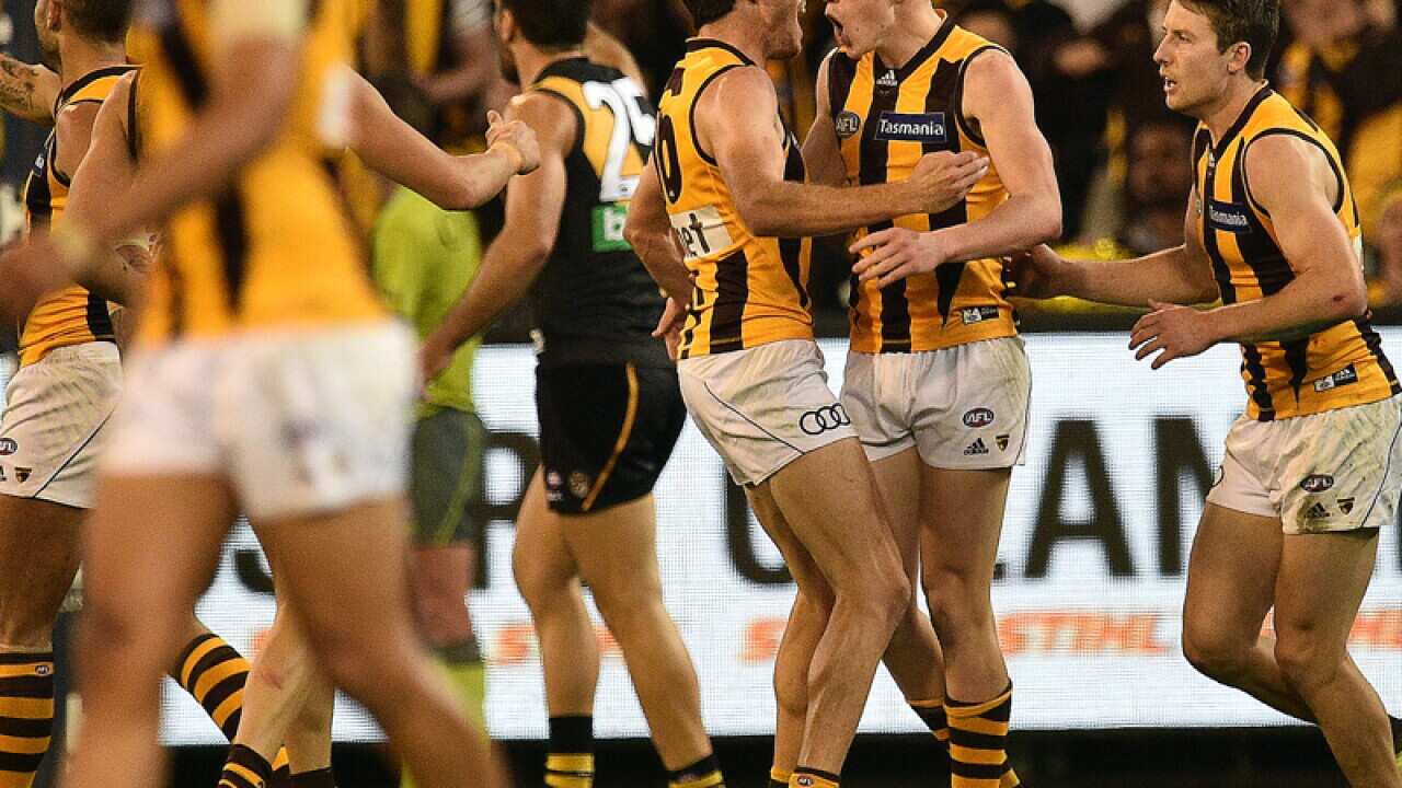 Hawks players react after James Sicily (2R) kicked a goal