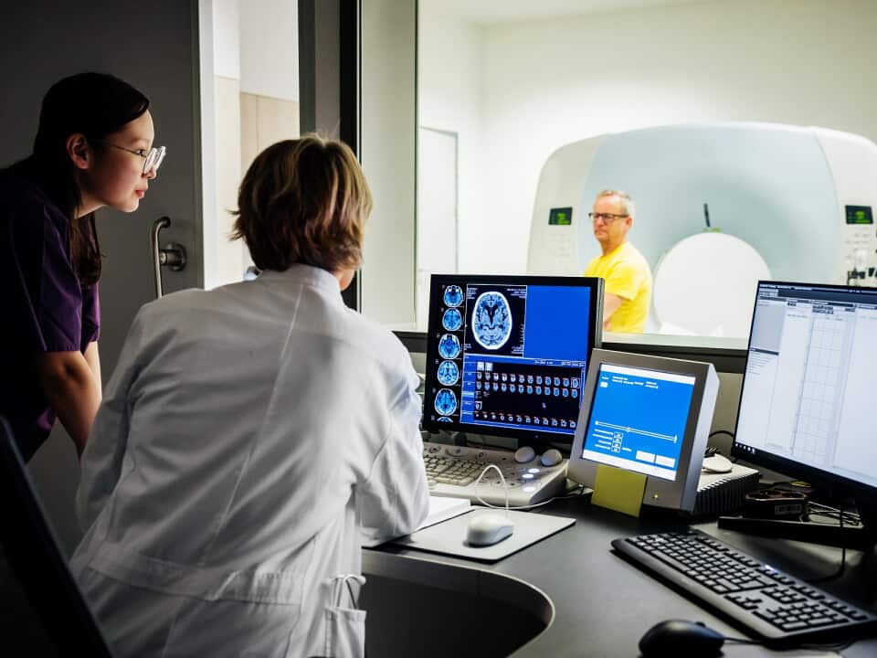 Female Doctor And Nurse Looking At Patient Data Of A CT-Scan