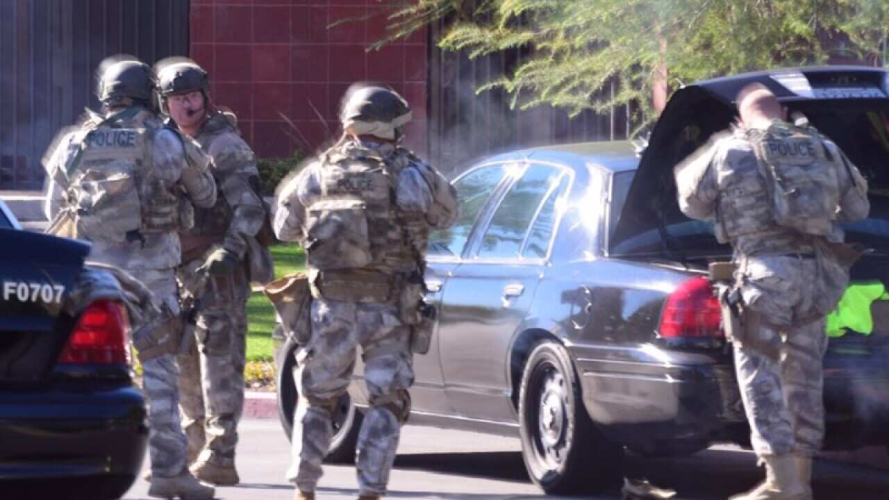 A swat team arrives at the scene of a shooting in San Bernardino