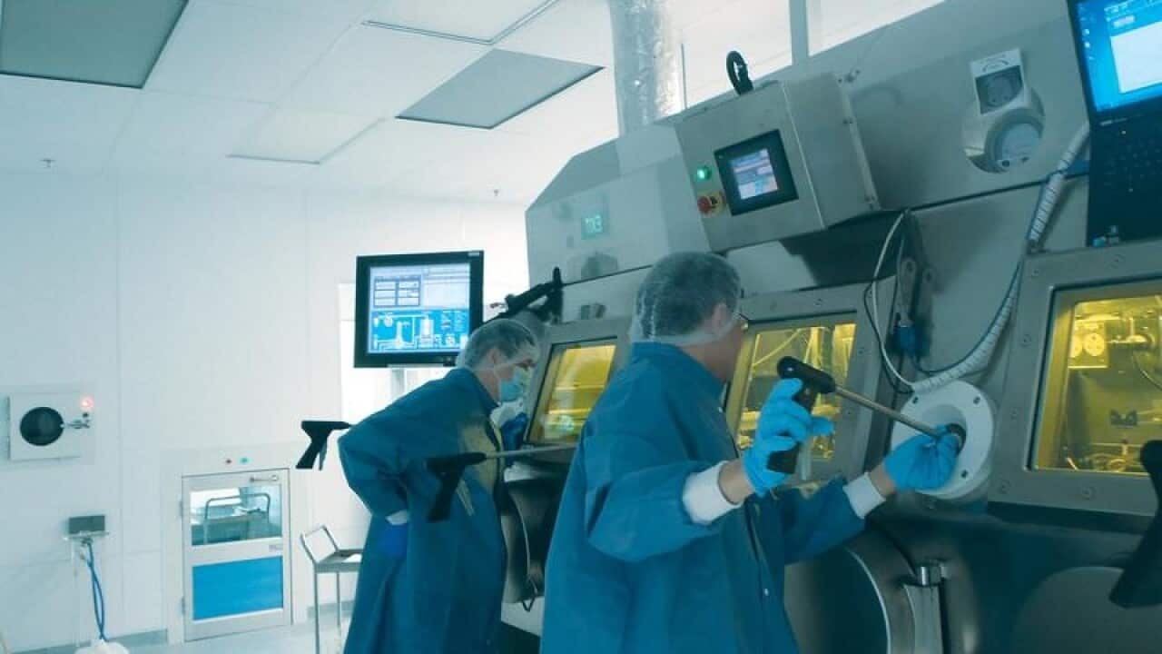 Researchers work inside a lab at Australian biomedical company Sirtex.
