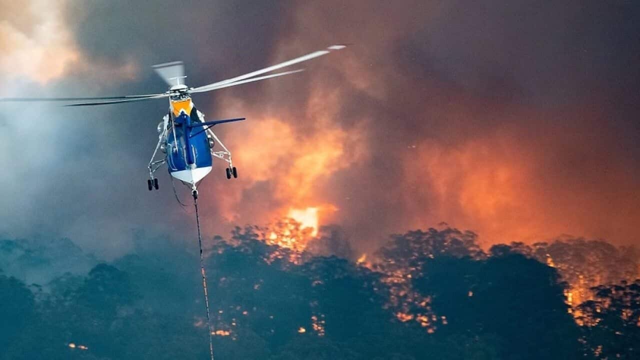 A firefighting helicopter tackles a bushfire near Bairnsdale in Victoria's East Gippsland region. Source: AAP