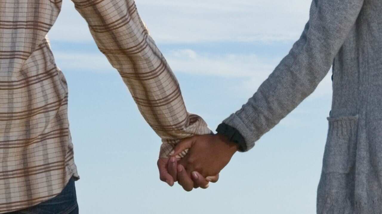 Couple holding hands