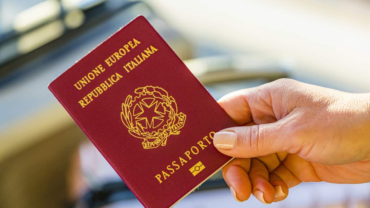 Close up of woman hand holding Italian passport