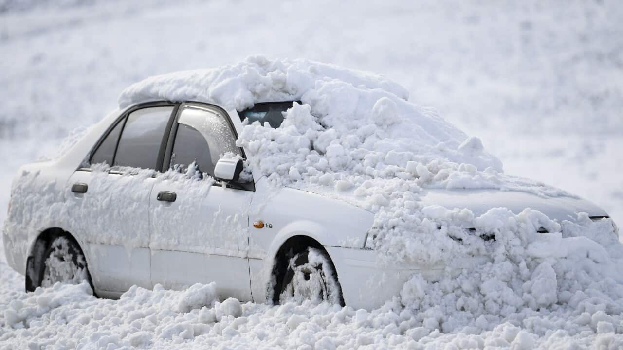 A snow-covered car is seen on the Monaro Highway near Cooma, NSW.