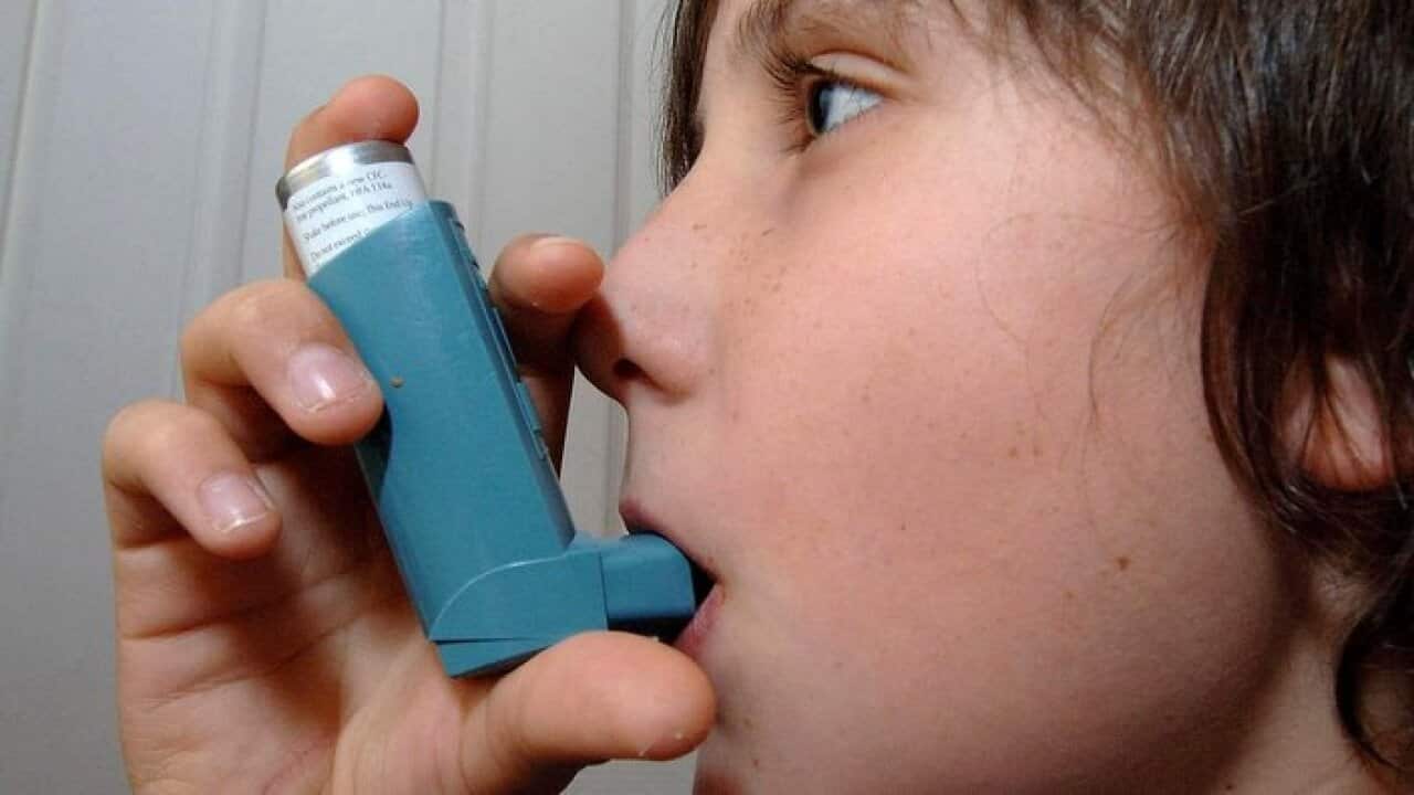 A child using an inhaler for treatment of Asthma
