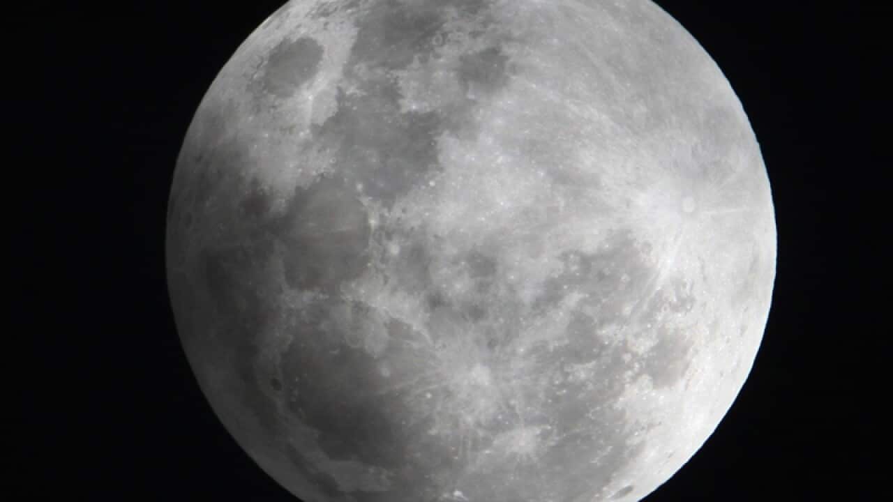 File photo, a faint shadow from the Earth is cast over the Moon