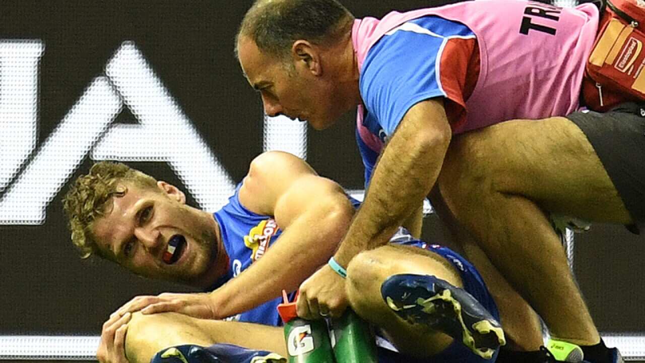 Jake Stringer of the Bulldogs (L) is seen after sustaining an injury
