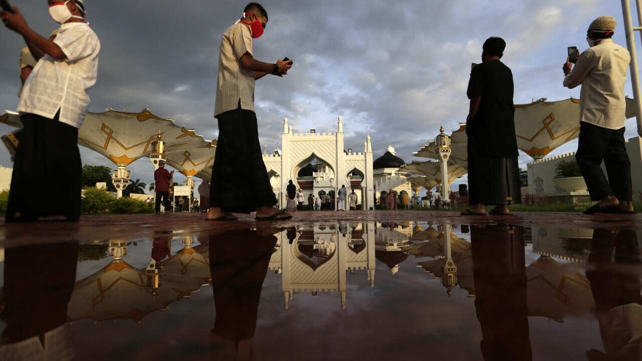 Indonesia worshippers enter the Baiturrahman Grand Mosque for Eid al Fitr prayers amid the coronavirus pandemic in Banda Aceh.