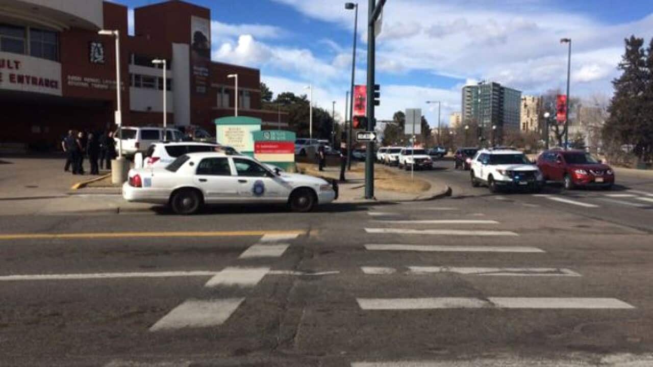 In this photo provided by 9NEWS/KUSA-TV Denver, authorities respond to the scene of a deadly shooting and stabbing at the National Western Complex