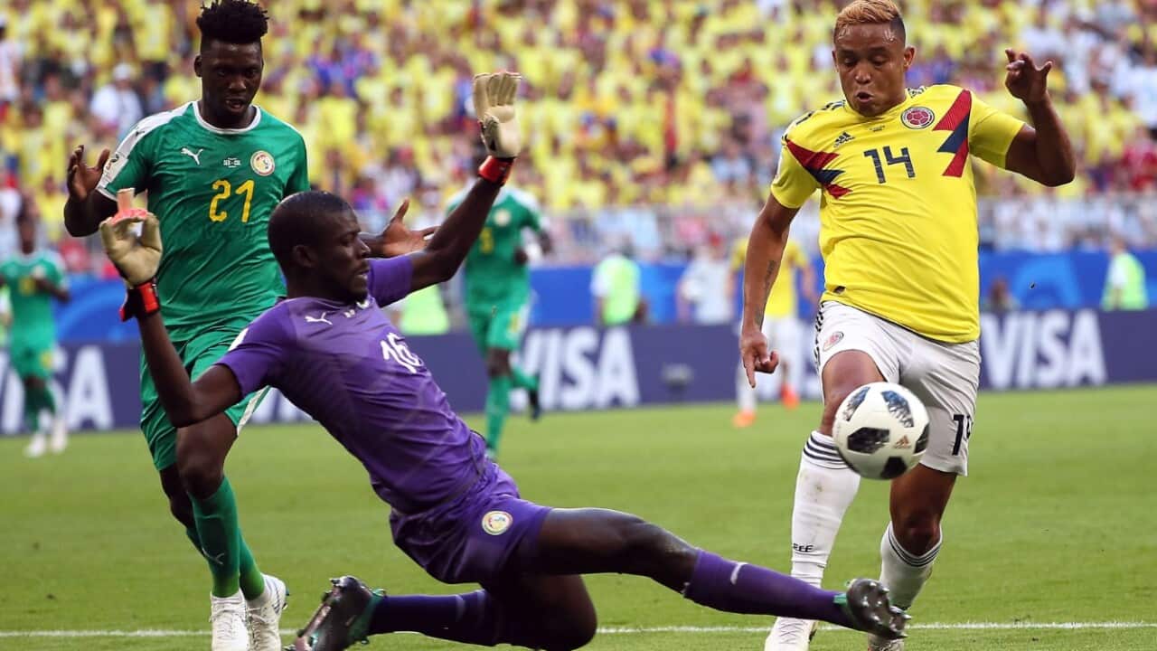 Luis Muriel of Colombia (R) and goalkeeper Khadim N'Diaye of Senegal in action during the FIFA World Cup 2018 group H preliminary round match