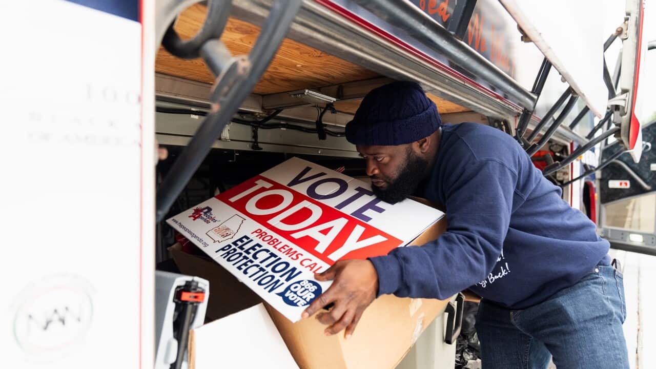 A worker in Atlanta from the National Coalition on Black Civic Participation loads signs encouraging people to vote (AAP)
