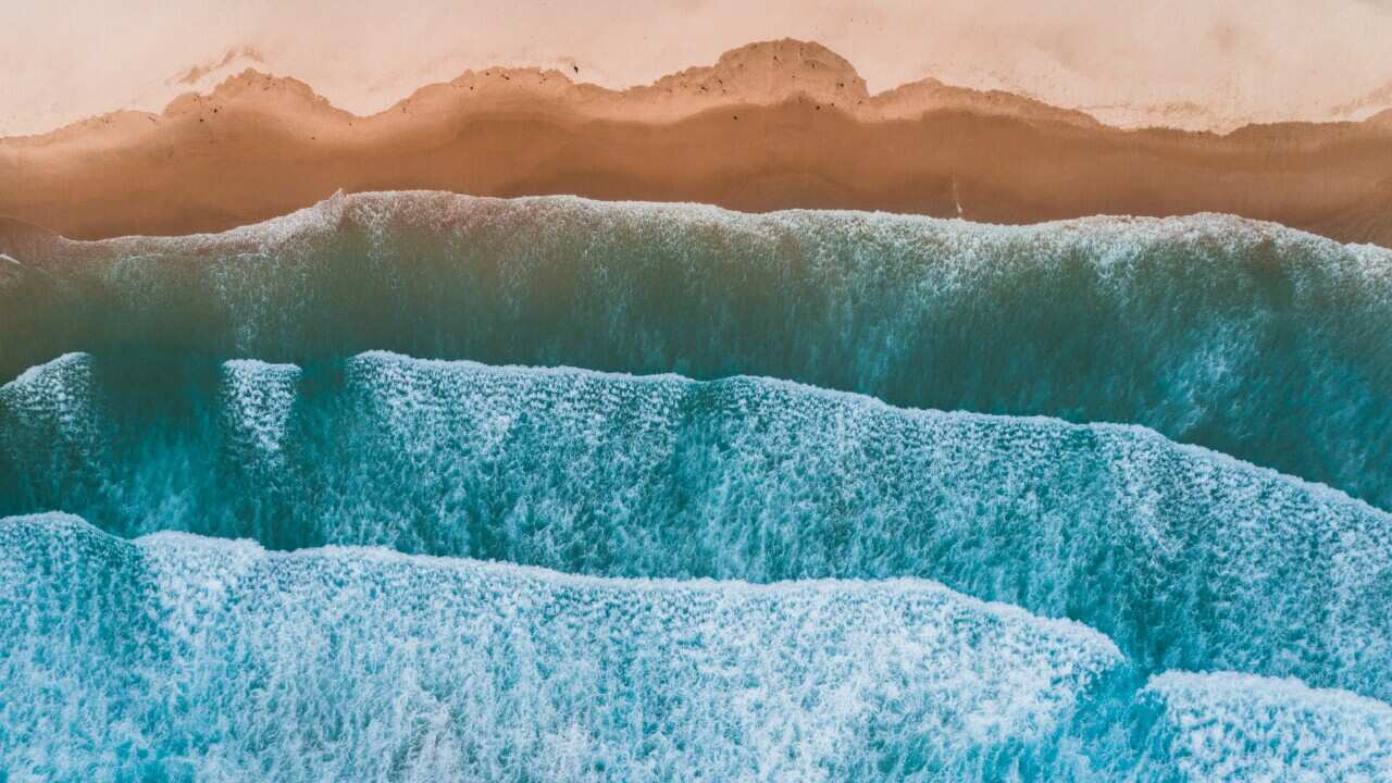 Aerial view of sea waves breaking on shore