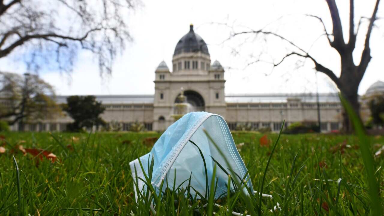 General view of a discarded single use mask face in Carlton Gardens, Melbourne, Wednesday, August 19, 2020. Victoria has recorded 216 new cases of coronavirus and 12 deaths in the past 24 hours (AAP Image/James Ross) NO ARCHIVING
