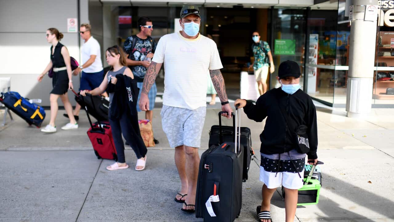 Passengers wearing face masks as they exit the domestic terminal in Brisbane airport.
