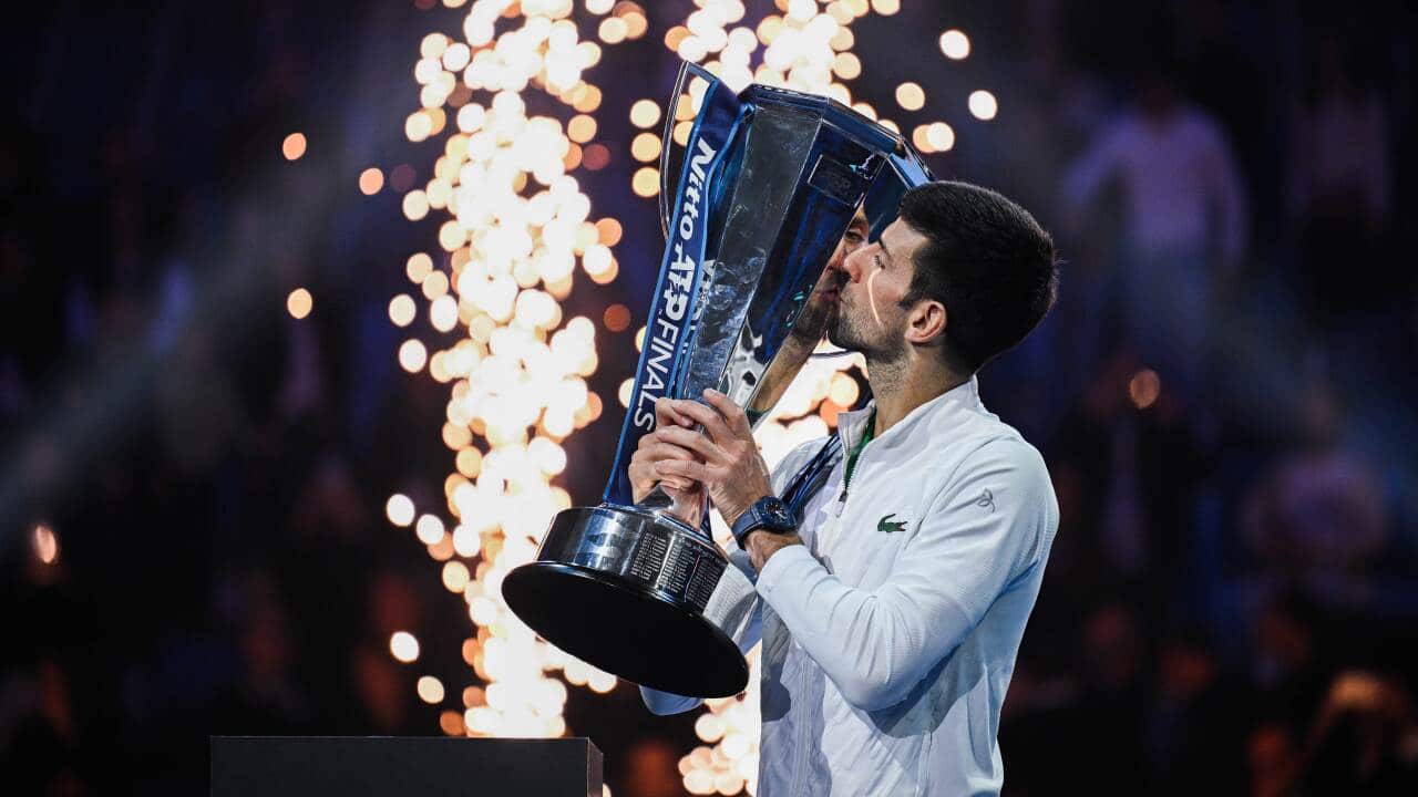 Novak Djokovic holds the ATP Finals 2022 trophy after defeating Kasper Ruud in Turin