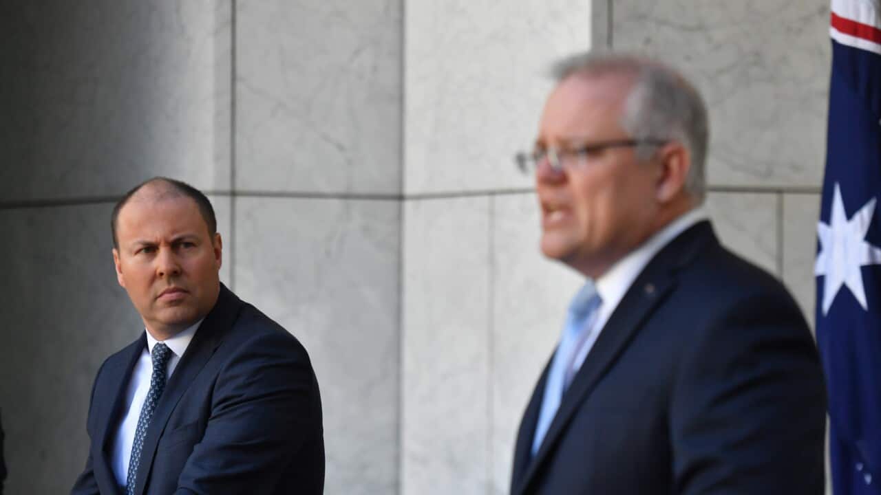 Treasurer Josh Frydenberg and Prime Minister Scott Morrison at a press conference to announce the government's coronavirus stimulus package at Parliament House in Canberra, Sunday, March 22, 2020. (AAP Image/Mick Tsikas) NO ARCHIVING