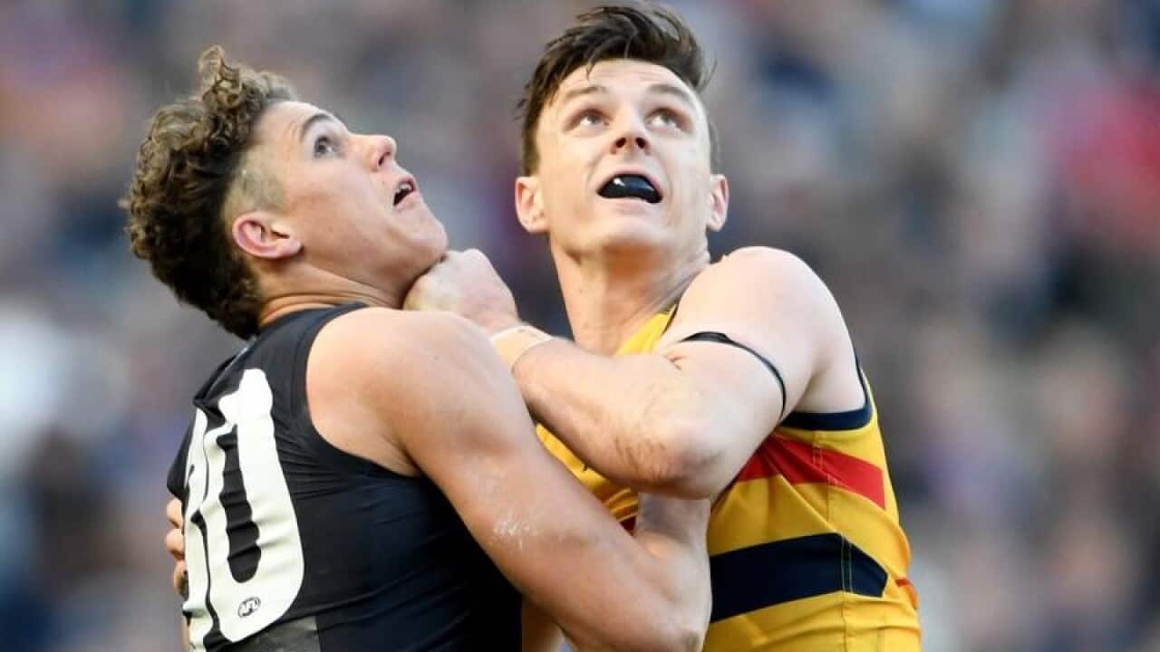 Charlie Curnow of the Blues and Jake Lever of the Crows