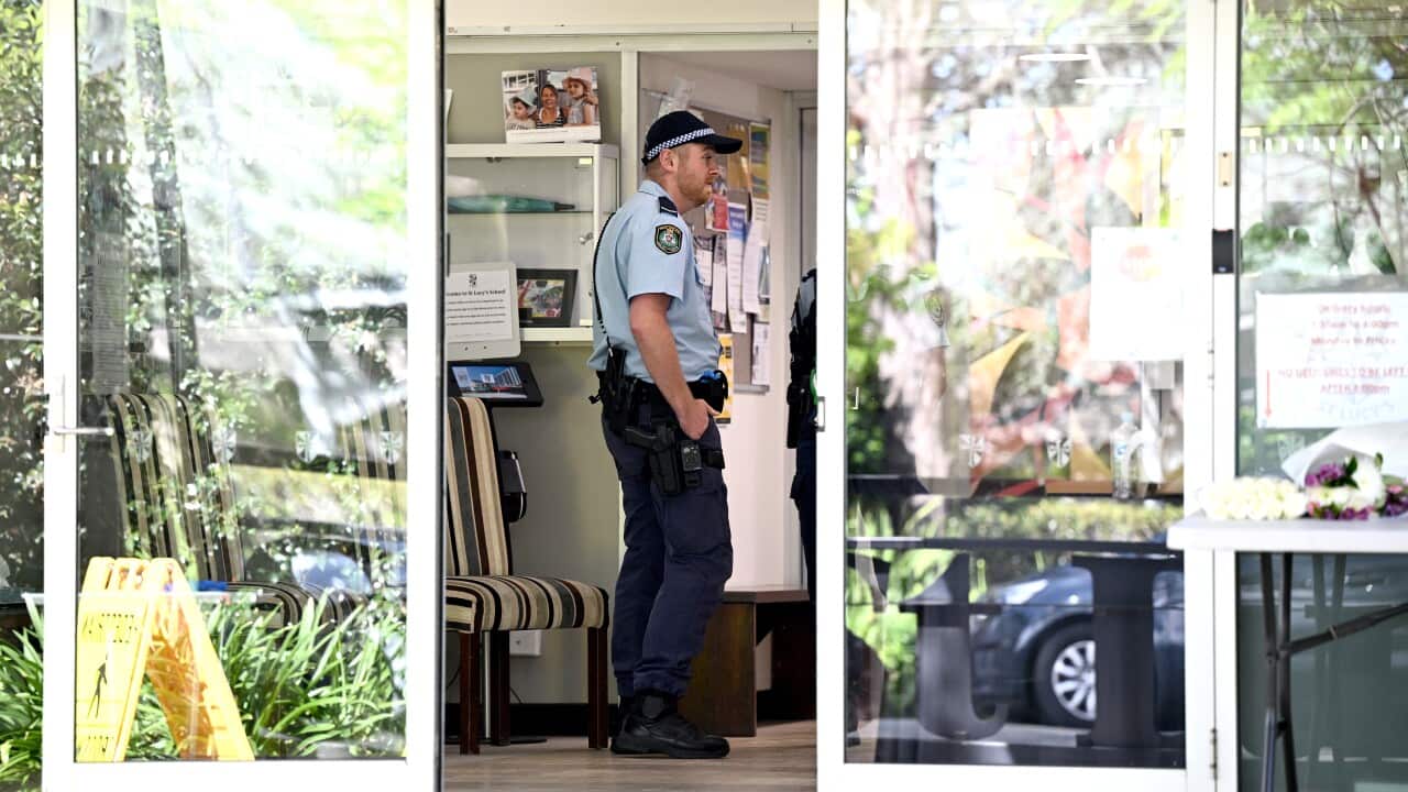 Police officer standing at in a doorway
