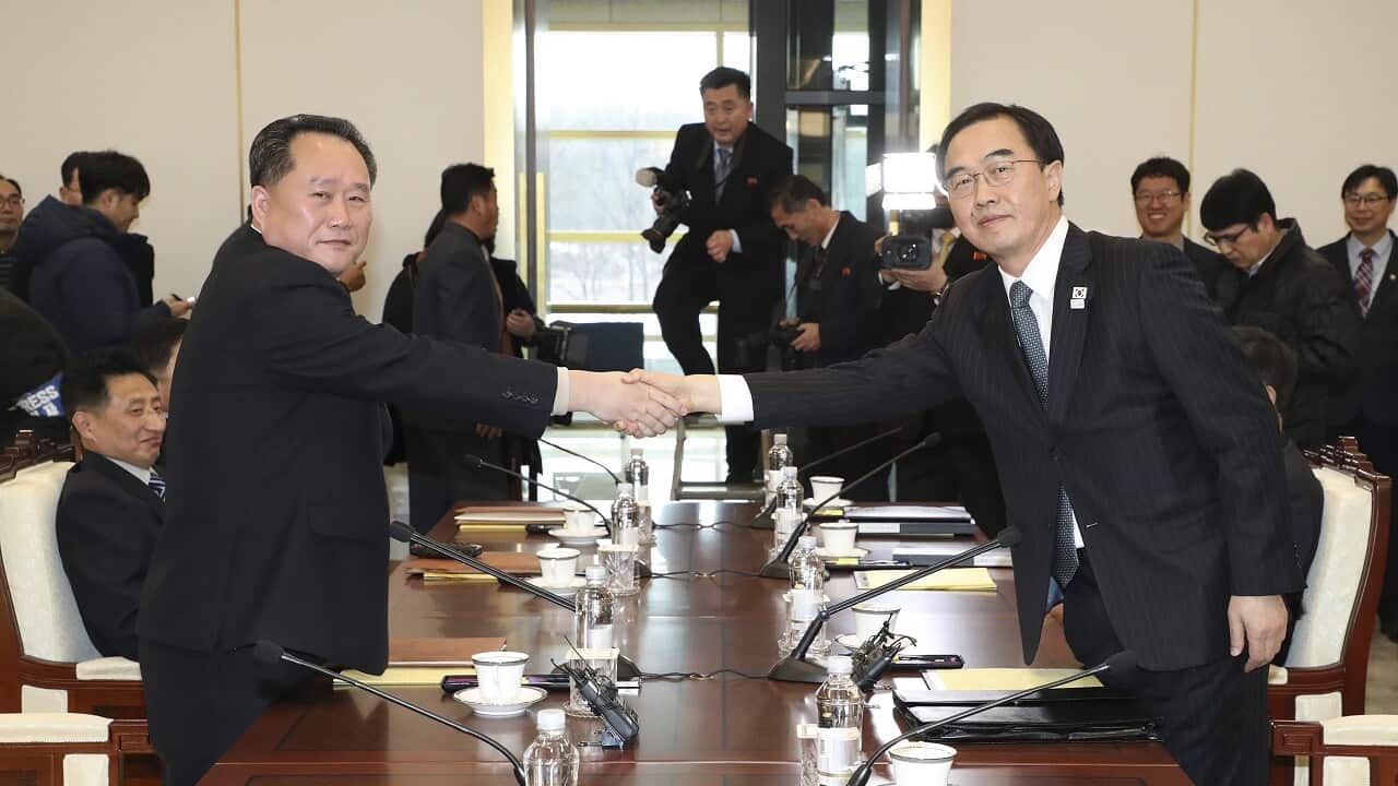 South Korean Unification Minister Cho Myoung-gyon, right, shakes hands with the head of North Korean delegation Ri Son Gwon before their meeting.