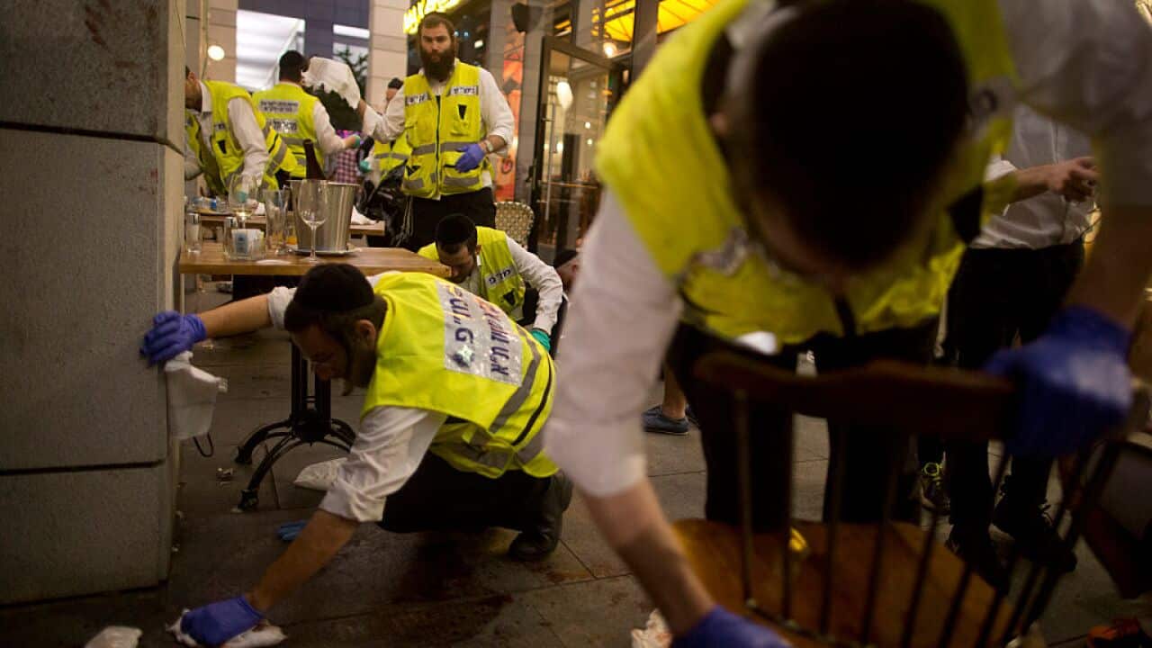 An identification, Extraction and Rescue team work at the scene of a shooting outside Max Brenner restaurant in Sarona Market.
