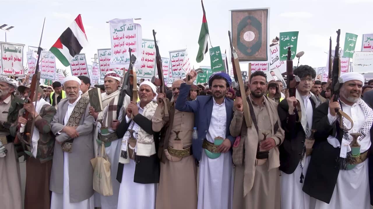 Protestors holding Yemeni and Palestinian flags (Reuters).jpg