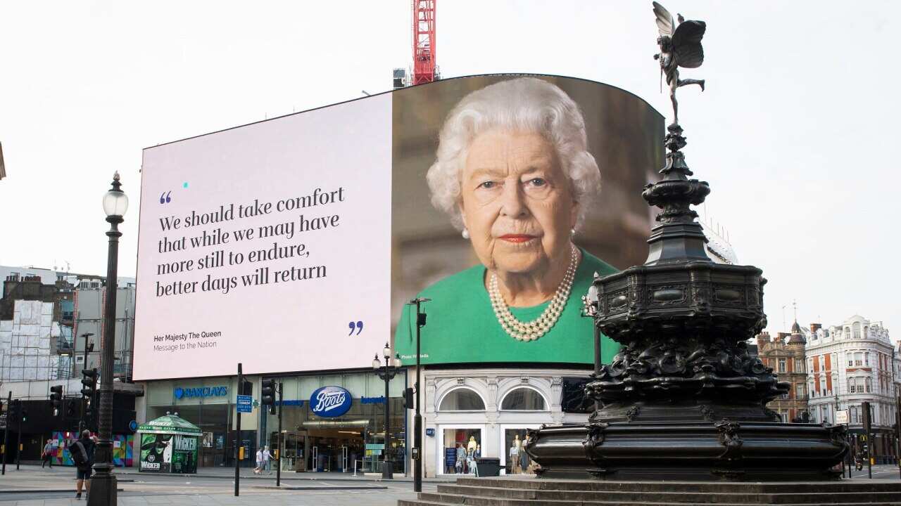 An image of the Queen overlooks a deserted Piccadilly Circus in London