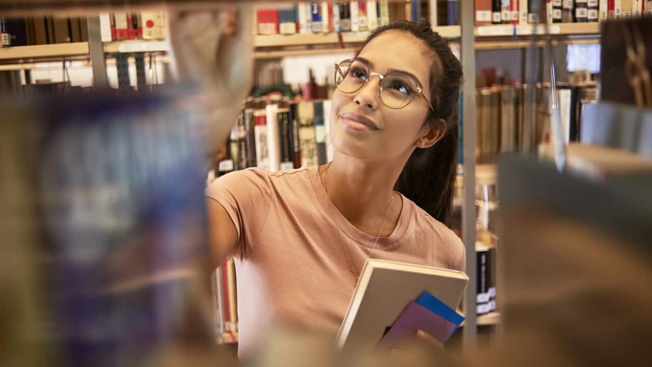young woman searching for a book