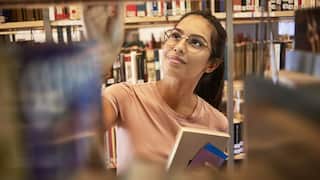 young woman searching for a book