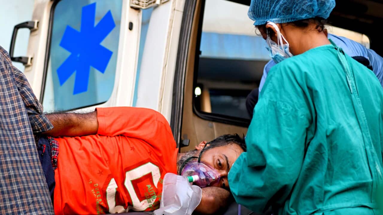 A COVID-19 patient on a stretcher is taken for a medical check up at MR Bangur government hospital in Kolkata