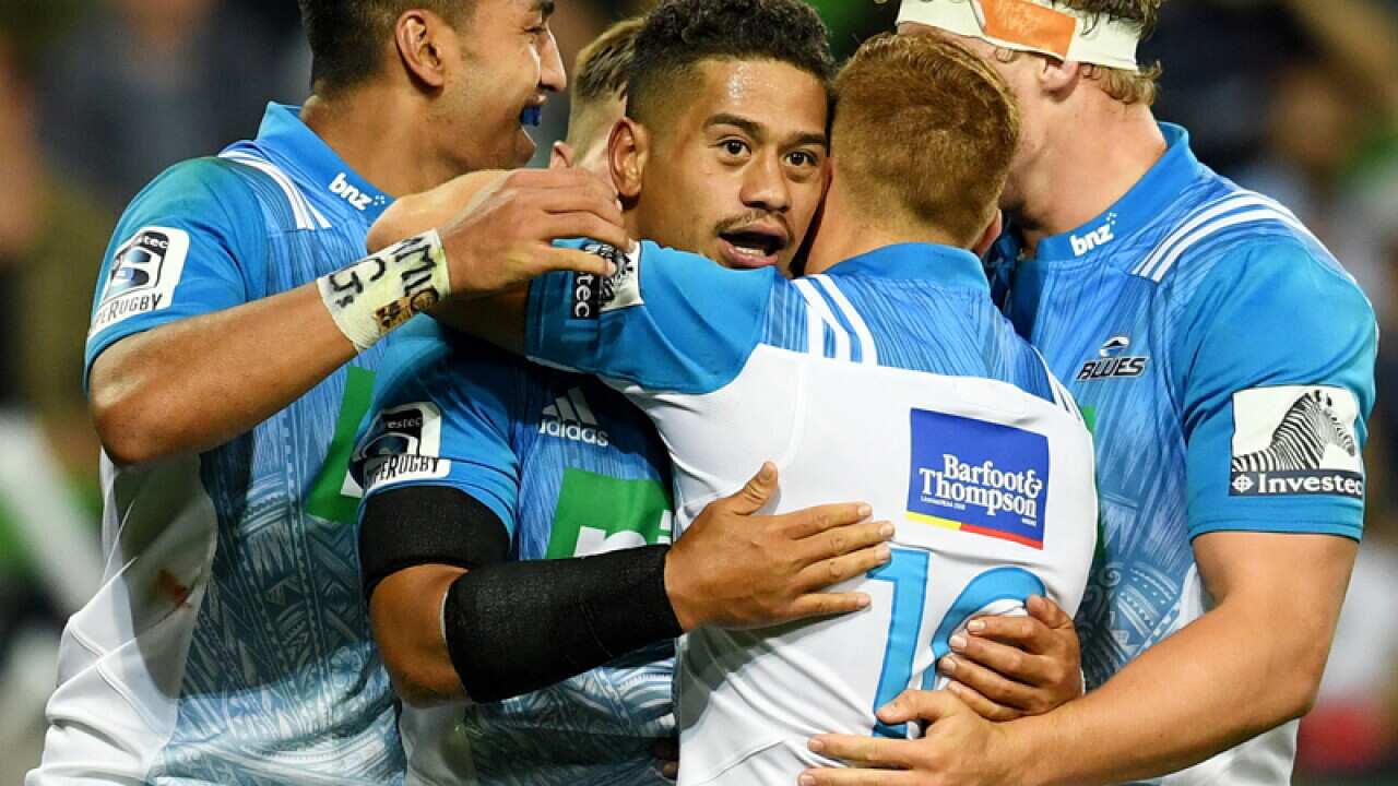 Augustine Pulu of the Blues (C) celebrates after scoring a try