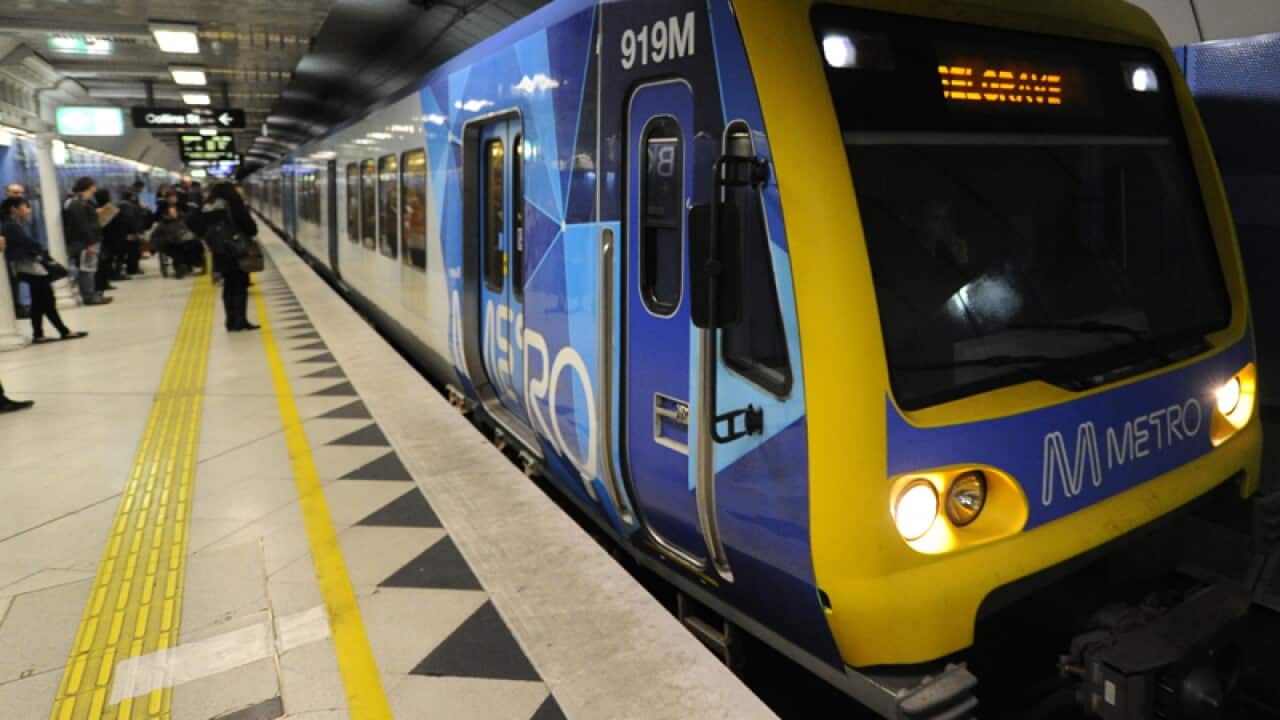 A Metro train approaches a Melbourne train station