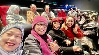 Maya Palupi Gvozden (person waving hand in red top) and Wida Chandler (person in black top and red hat) in the ACMI cinema after watching “Agak Laen: Menyala Pantiku!” film at the 20th Indonesian Film Festival in Melbourne – 10 May 2066. Photo courtesy: Widha Chaidir.