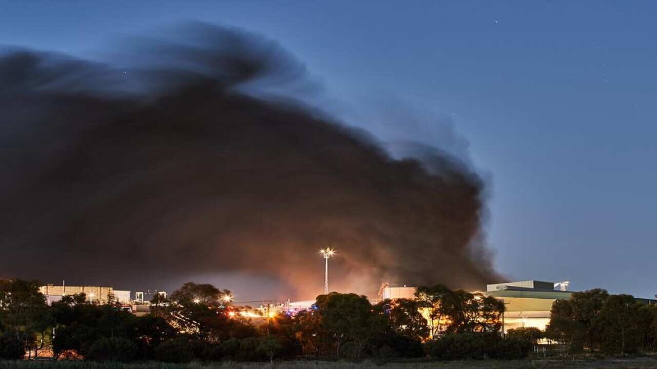 Smoke rises from a fire at the Thomas Foods International meatworks
