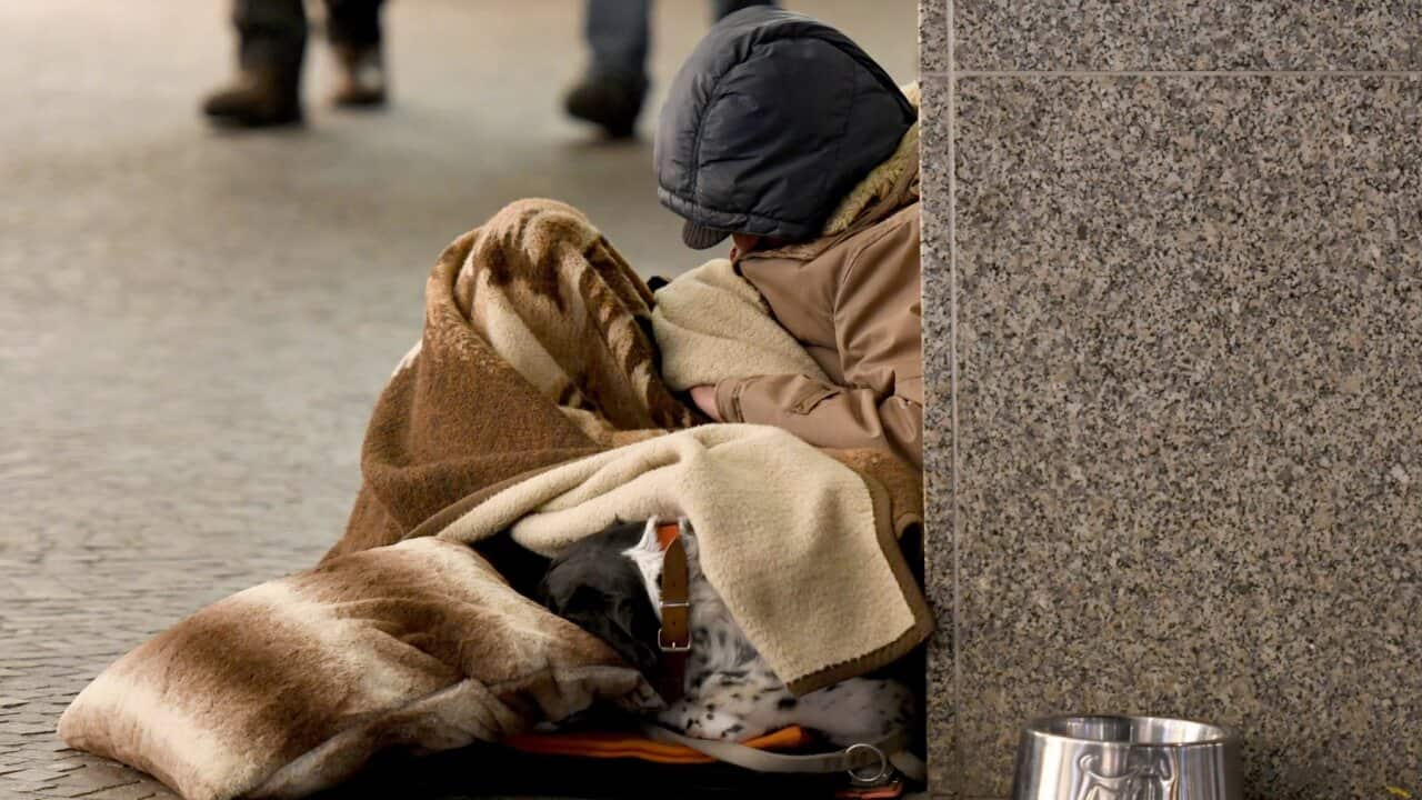 A homeless man sleeping in the street