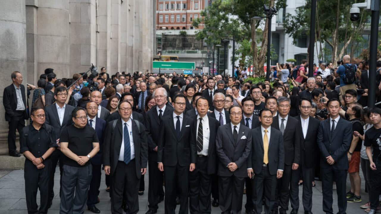 Hundreds of lawyers and legal professionals dress in black take part during the silent march against the extradition bill from the Court of Final Appeal to the Central Government Complex in Hong Kong (AAP)