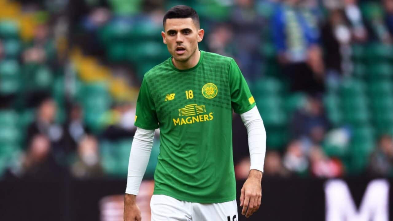 Tom Rogic warms up before a match with Celtic