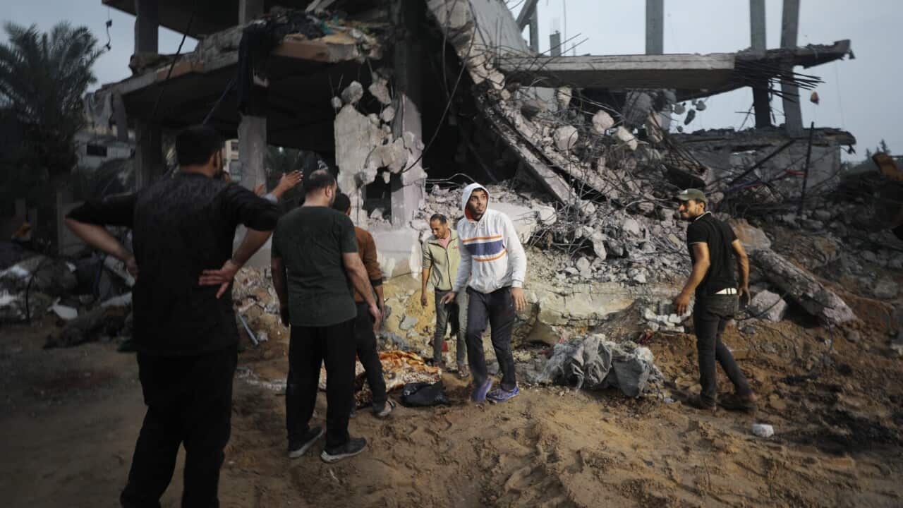 Palestinians search for bodies and survivors among the rubble of a destroyed house following Israeli airstrikes on Deir Al Balah in the southern Gaza Strip.