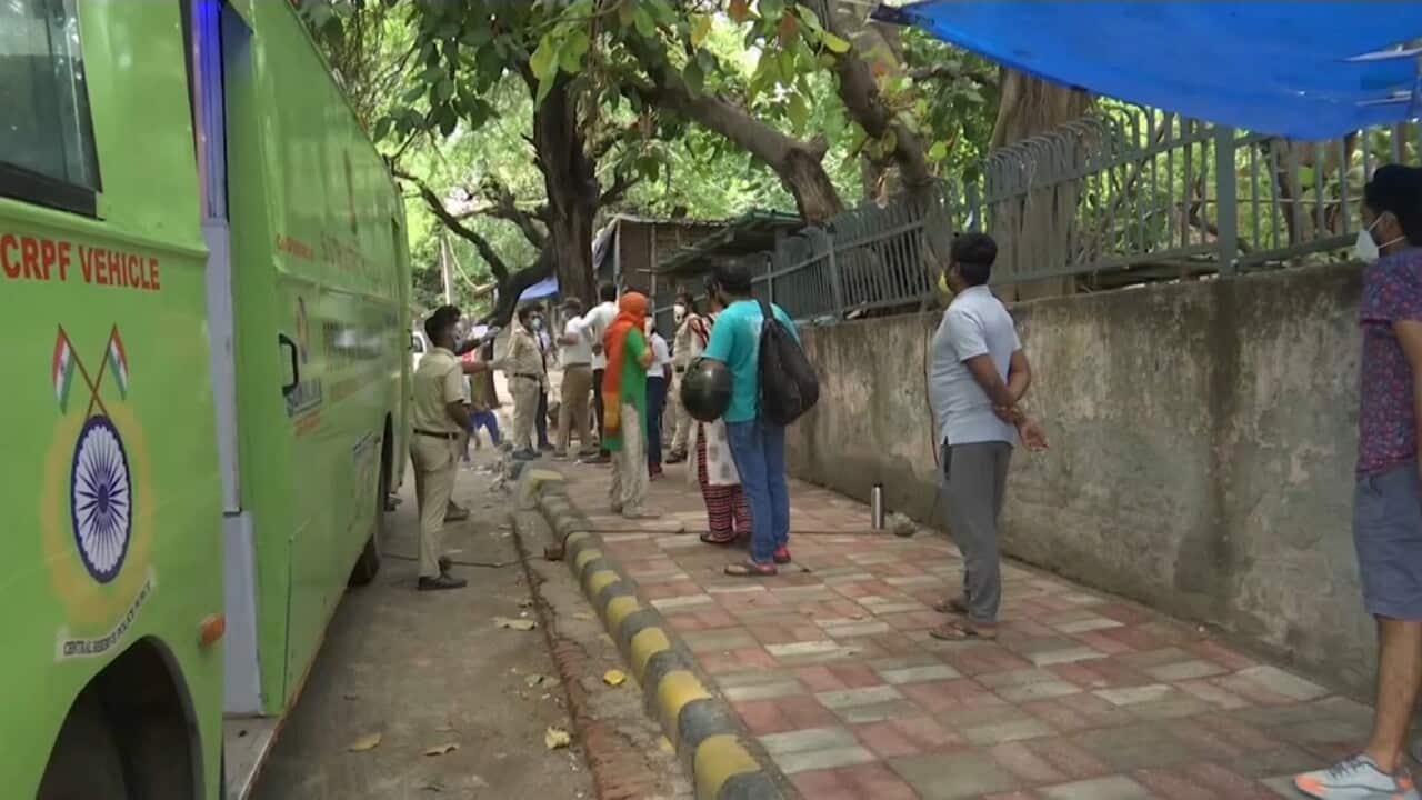 New Delhi locals queue to get tested for coronavirus at a mobile clinic