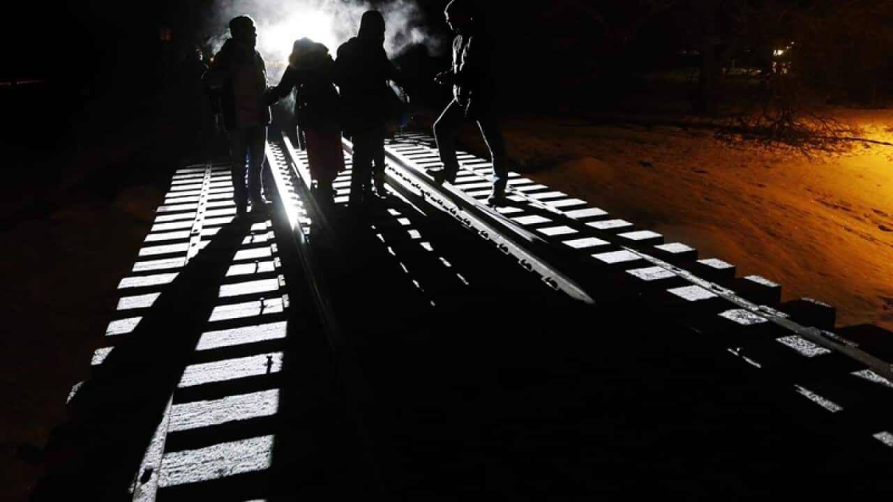 Migrants from Somalia cross into Canada from the United States