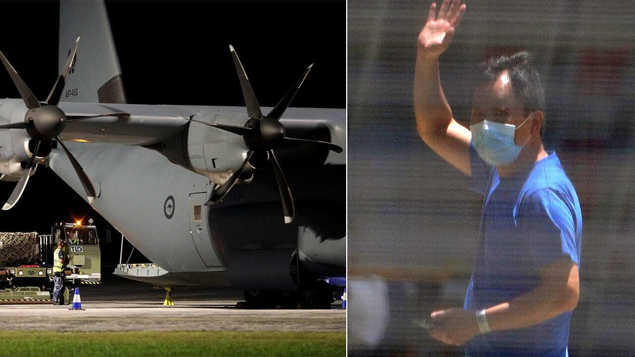 An evacuee waves from inside the Christmas Island detention centre and (left) a RAAF flight brings in supplies. The evacuees could soon be flown home.