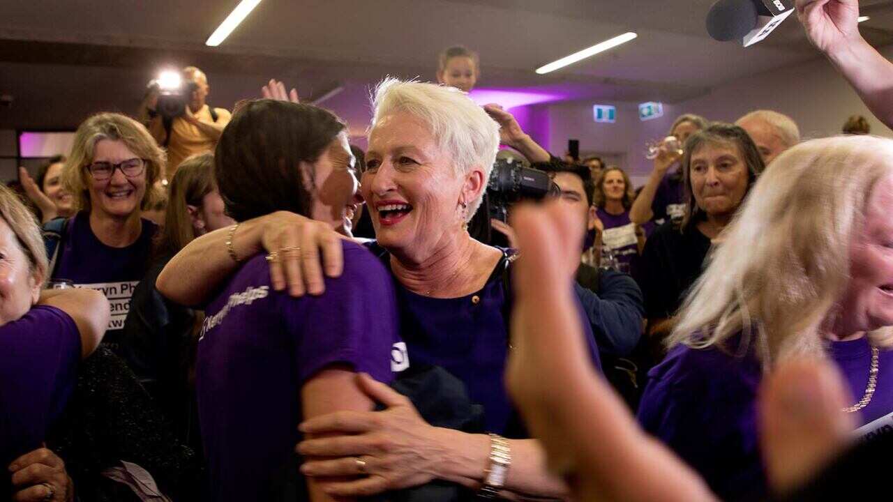 A victorious Kerryn Phelps celebrates with supporters after the election was called on Saturday night.