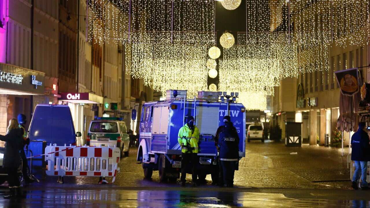 Policemen and a truck of the technical assistance (THW) stand in a pedestrian zone in the city center in Trier, Germany, 01 December 2020. According to reports, at least two people have been killed and several injured after a car with high speed hit into