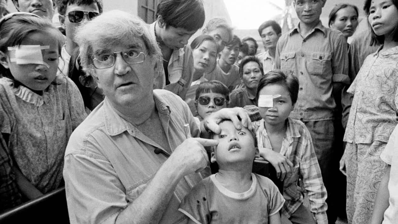 Professor Fred Hollows examines the eye of Tran Van Giap in Hanoi in 1992.