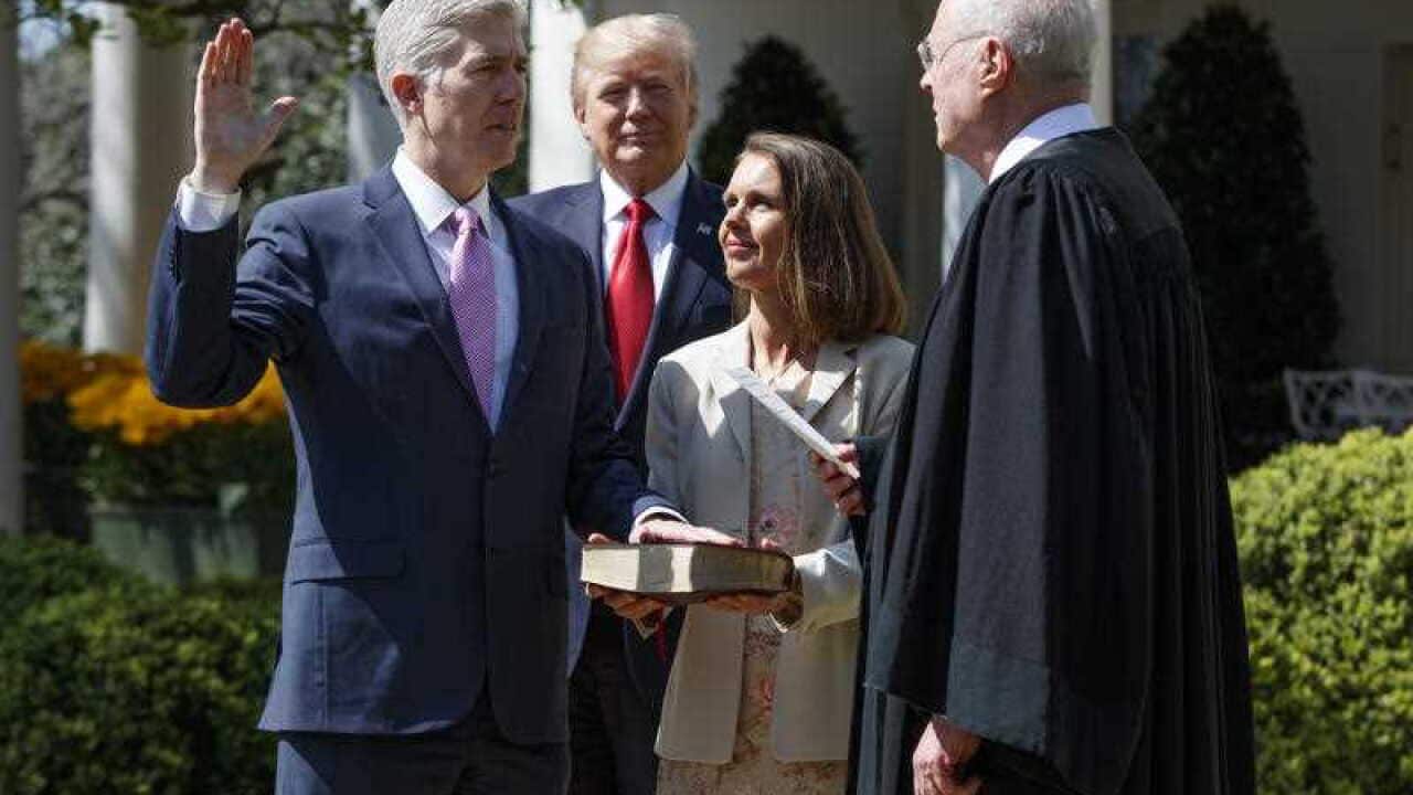 President Donald Trump watches as Supreme Court Justice Anthony Kennedy administers the judicial oath to Judge Neil Gorsuch