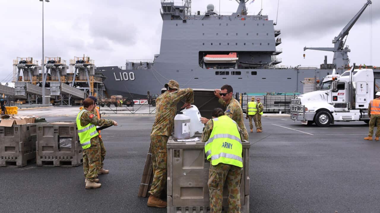 Emergency relief supplies are loaded onto the HMAS Choules