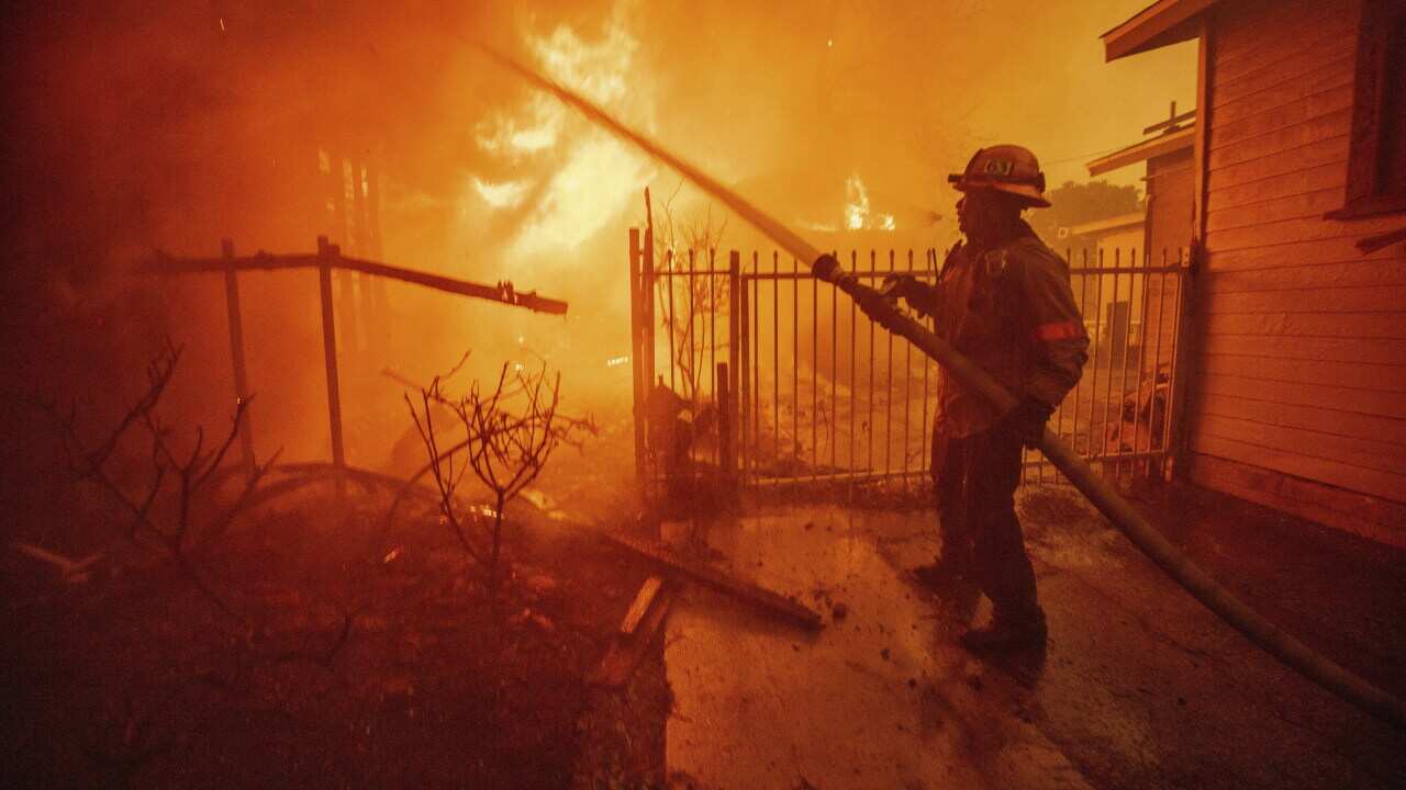 A firefighter battles a fire