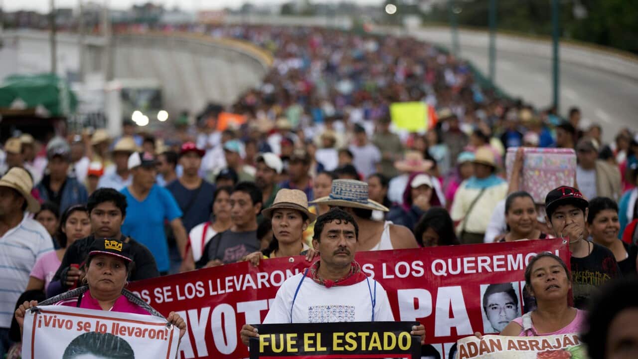 Relatives of the 43 missing Ayotzinapa teachers' college students lead a march marking the one-year anniversary of the students' disappearances. (AP)