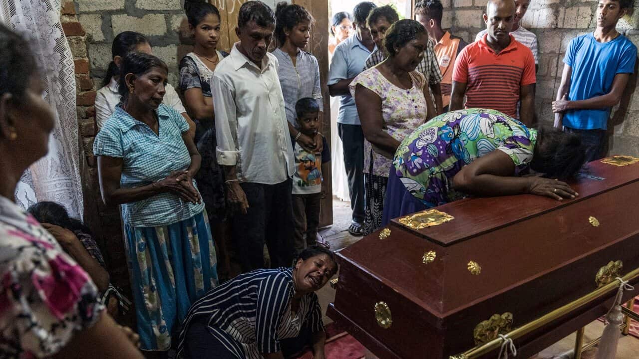 Relatives of Sneha Savindi, 11, mourn at her wake in Negombo, Sri Lanka, on Monday.