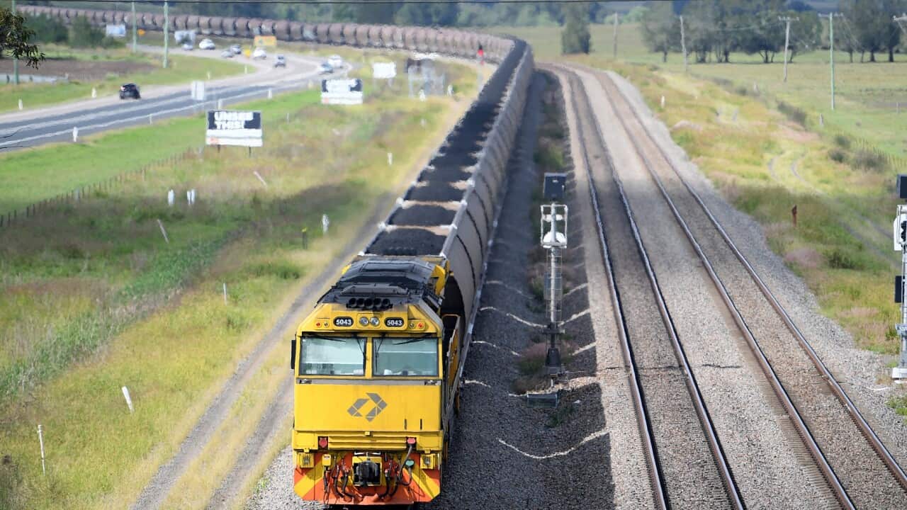 A loaded coal train passes through the outskirts of Singleton, NSW